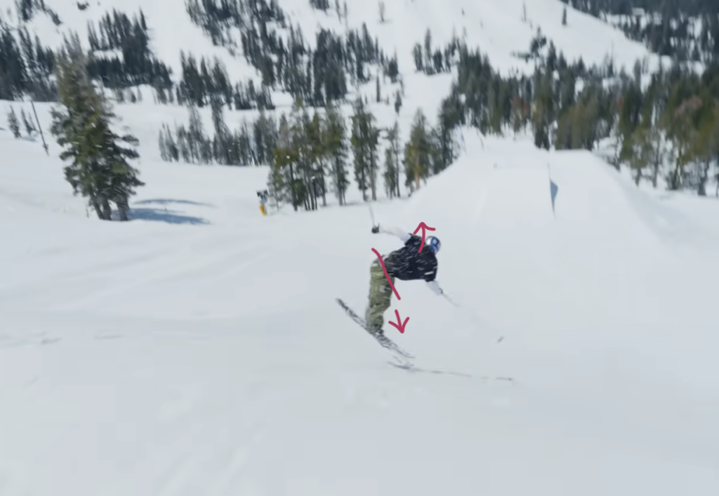Skier performing third part of trick