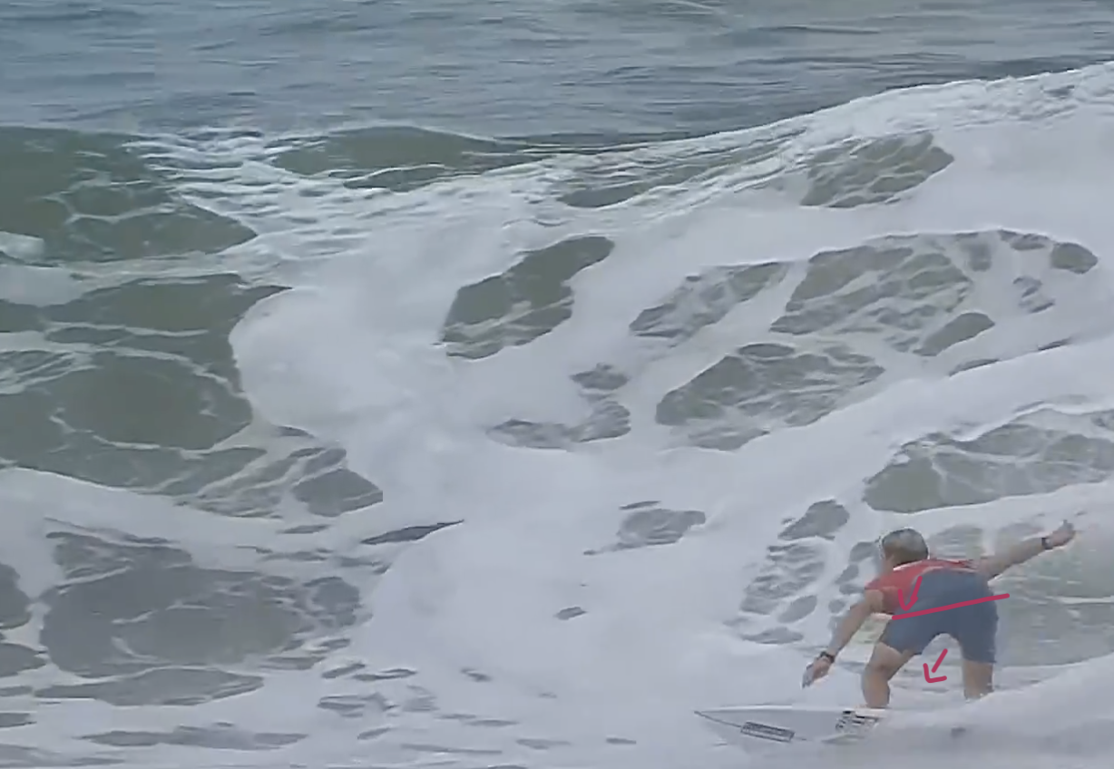 Surfer loading up for a turn in a wave