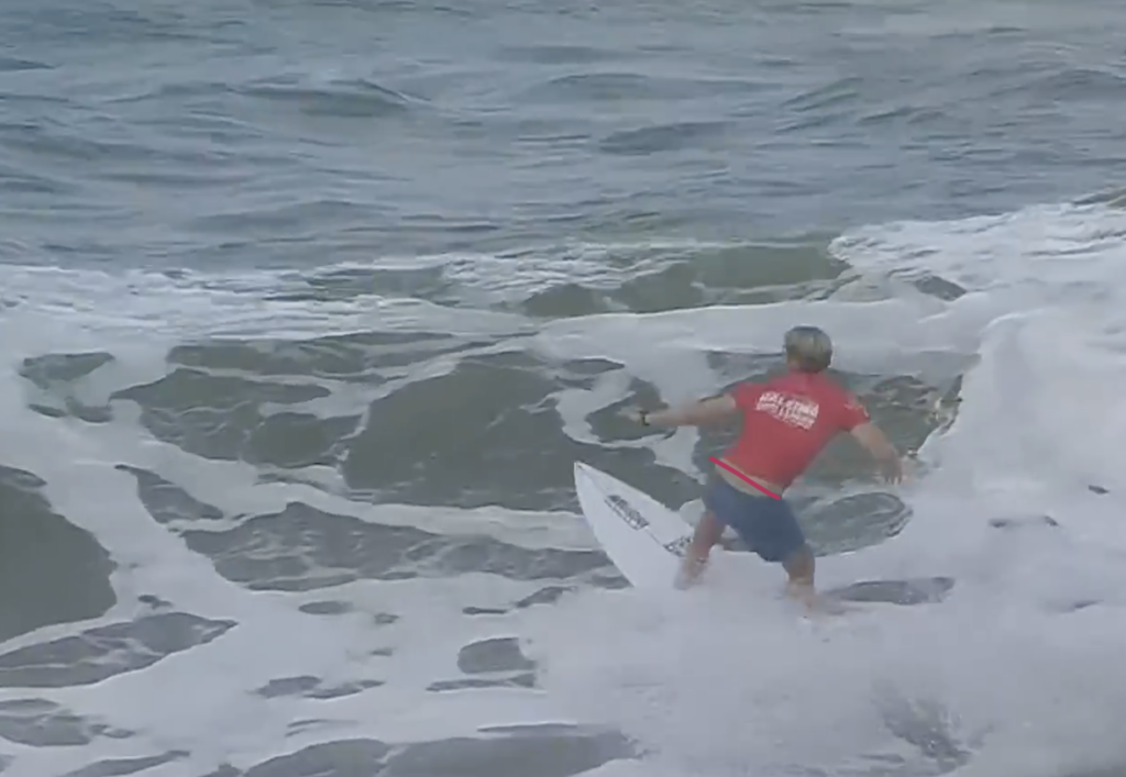 Surfer loading up for a turn in a wave