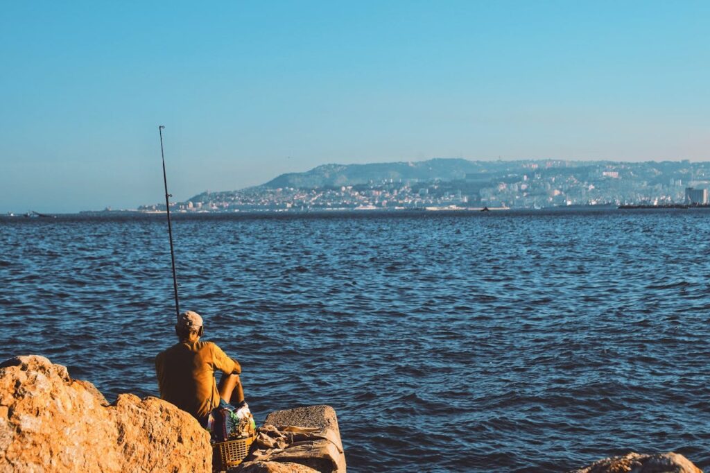 A photo of a fisherman next the Algerian Ocean