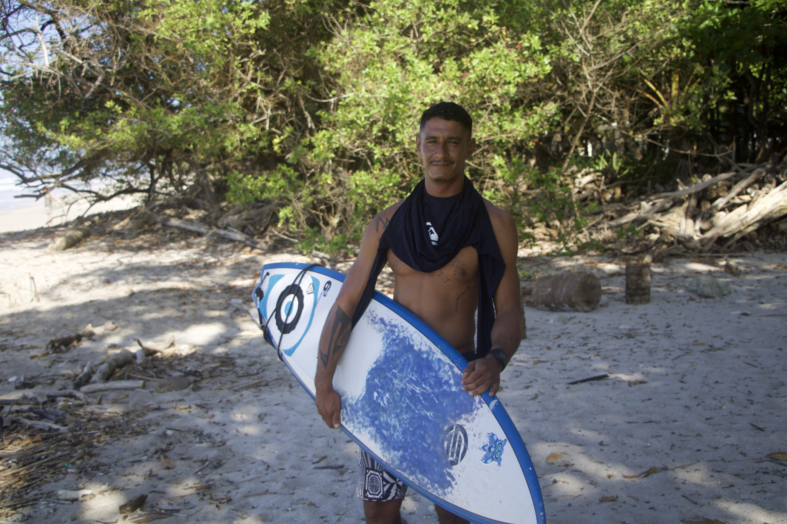 Maykol, founder and owner of Mahalo Surf School posing for the shot.