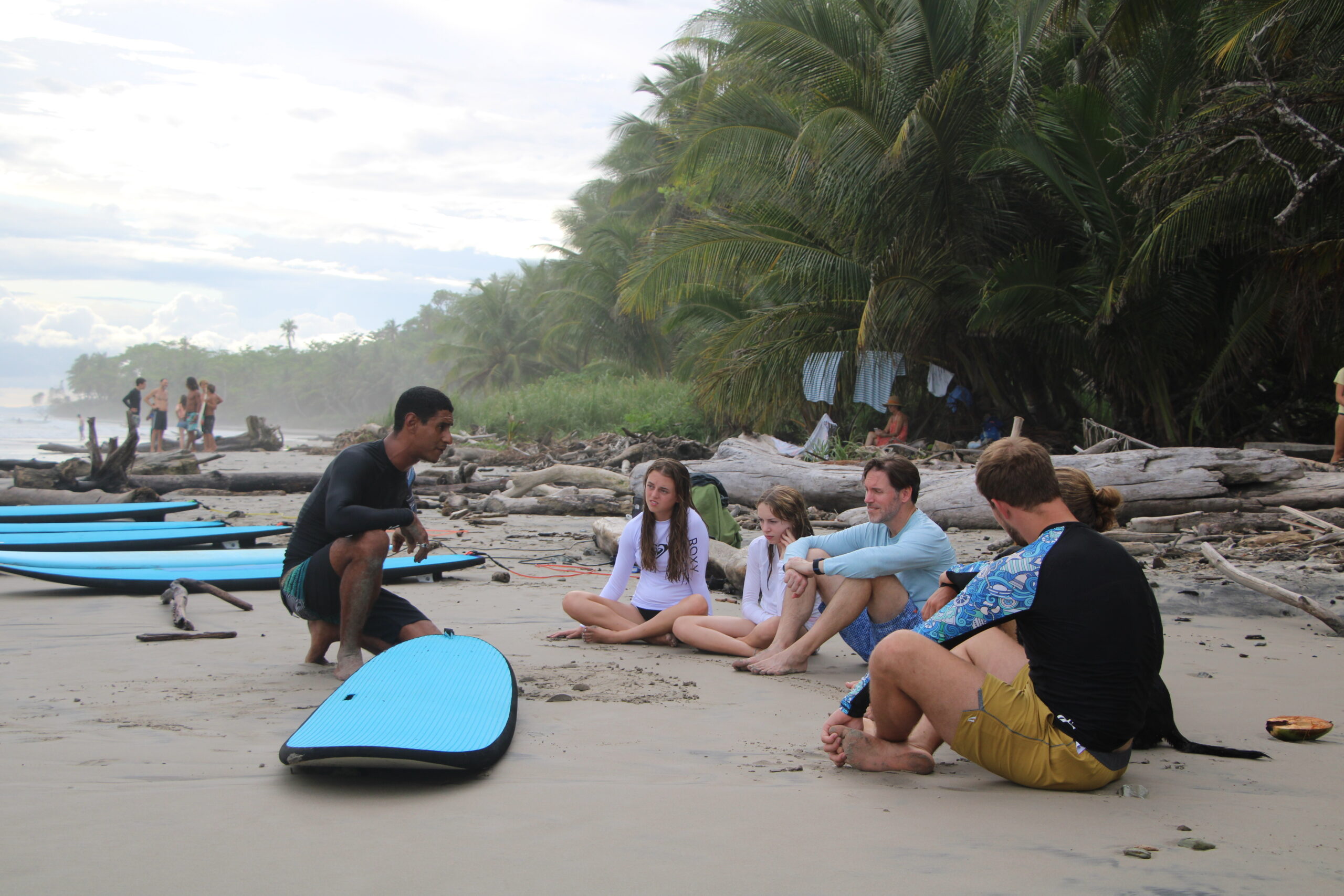 A surf instructor teaching and sharing some insights before a session. Photo provided by Mahalo Surf Club.