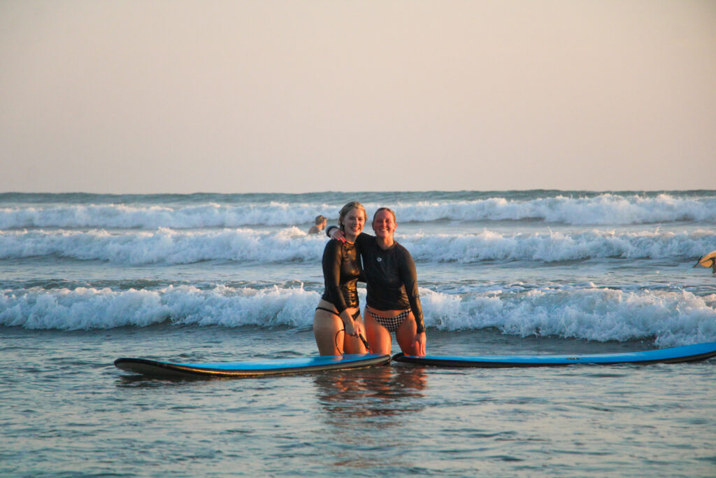 Two surfers enjoying some time together with Mahalo Surf Club.