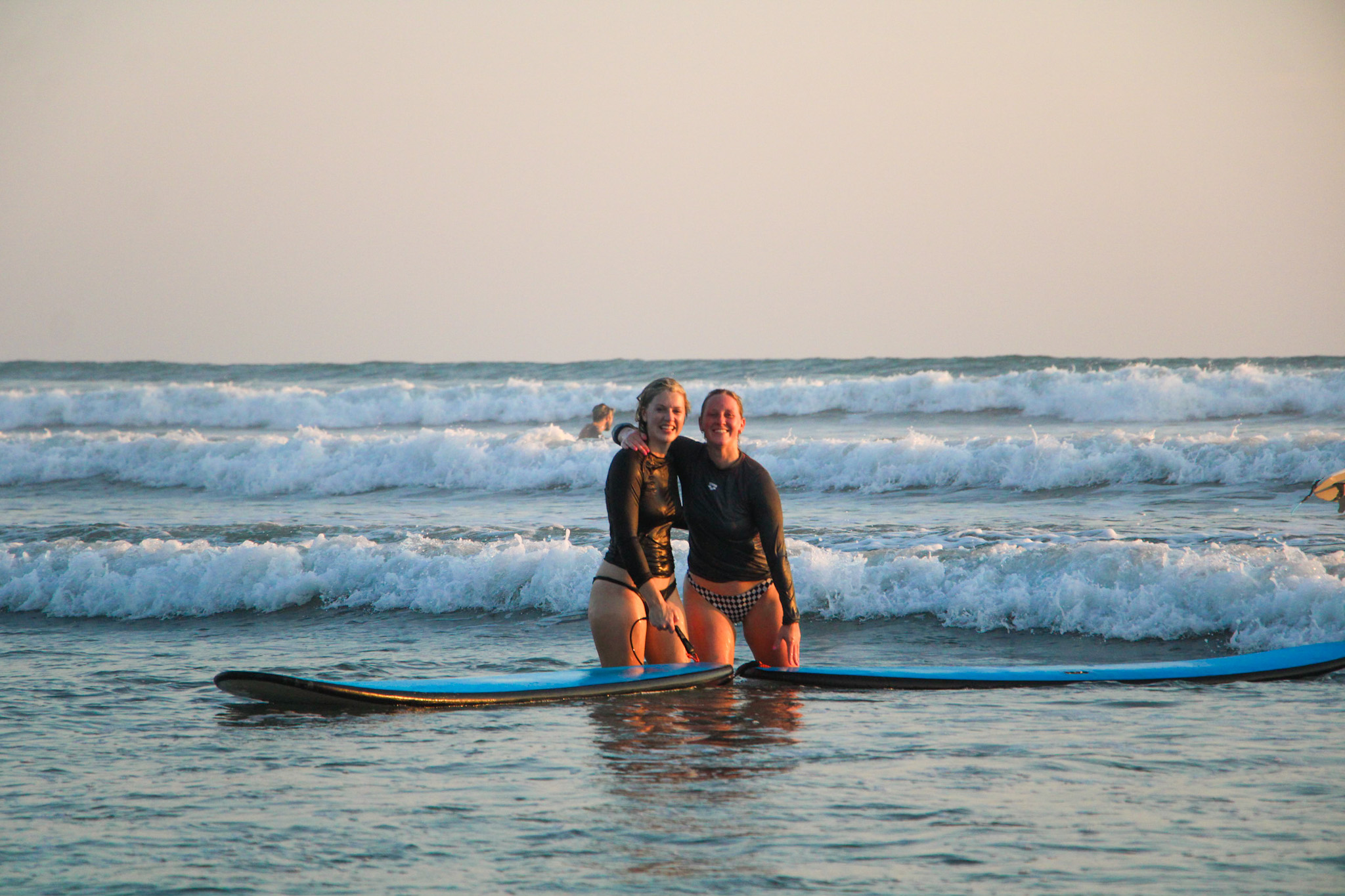 Two surfers enjoying some time together with Mahalo Surf Club.