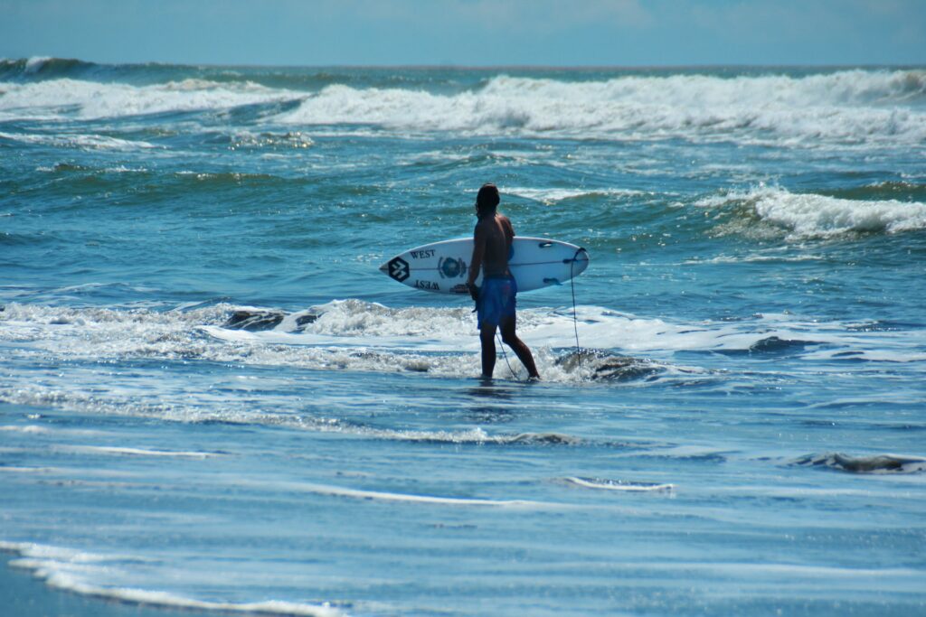 Surfer walking on the beach