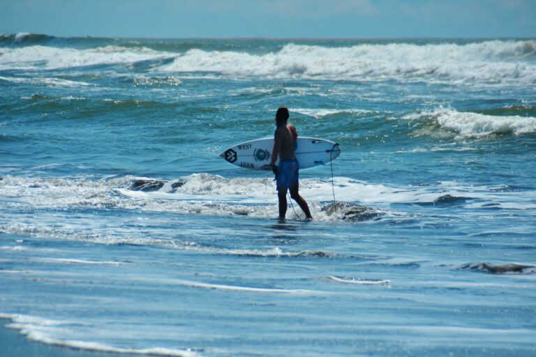 Surfer walking on the beach