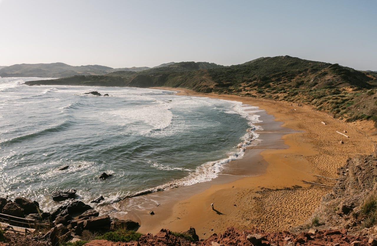 A beautiful beach in Menorca, Spain with the ocean and some waves