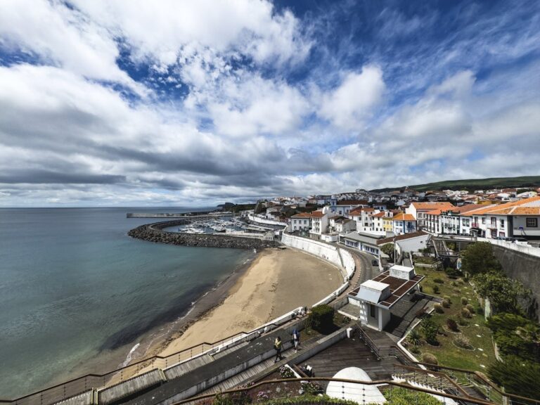 Birds eye view of houses, a beach, and some ocean