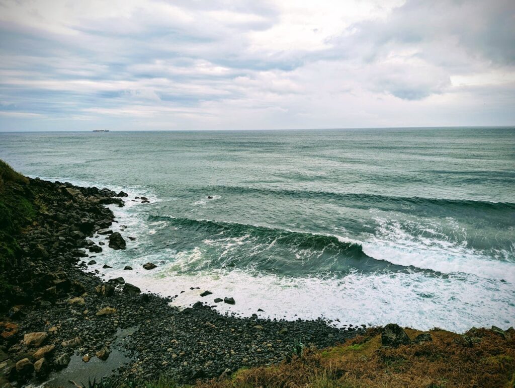 A rocky beach with some waves breaking during the store