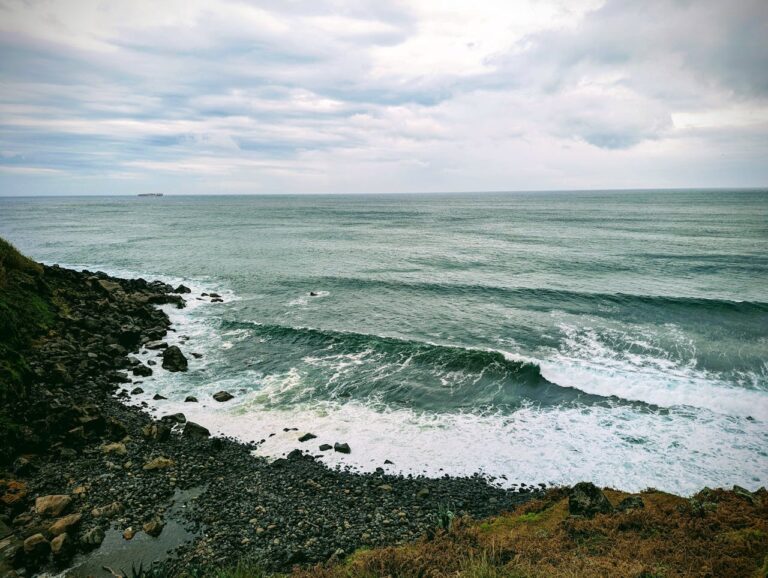 A rocky beach with some waves breaking during the store