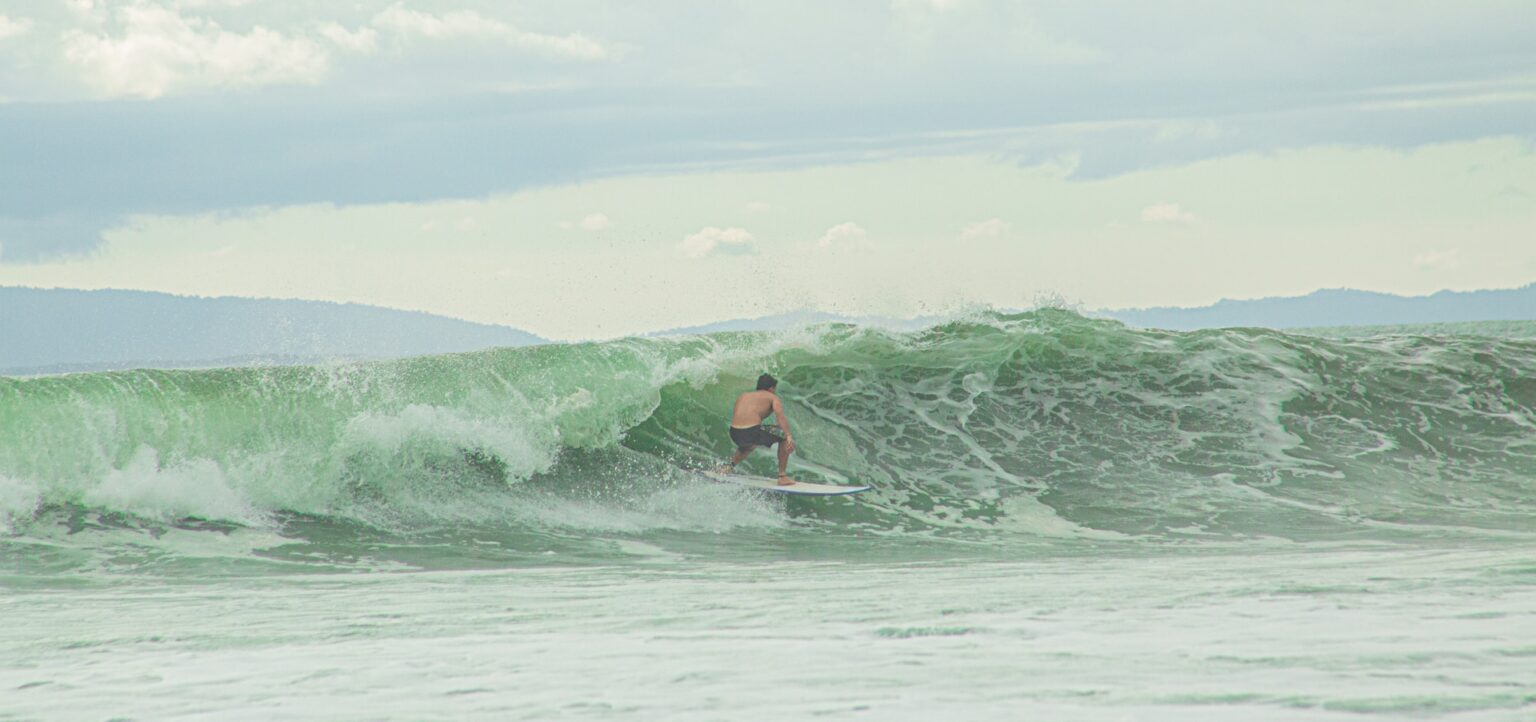 Surfer surfing Pavones, Costa Rica