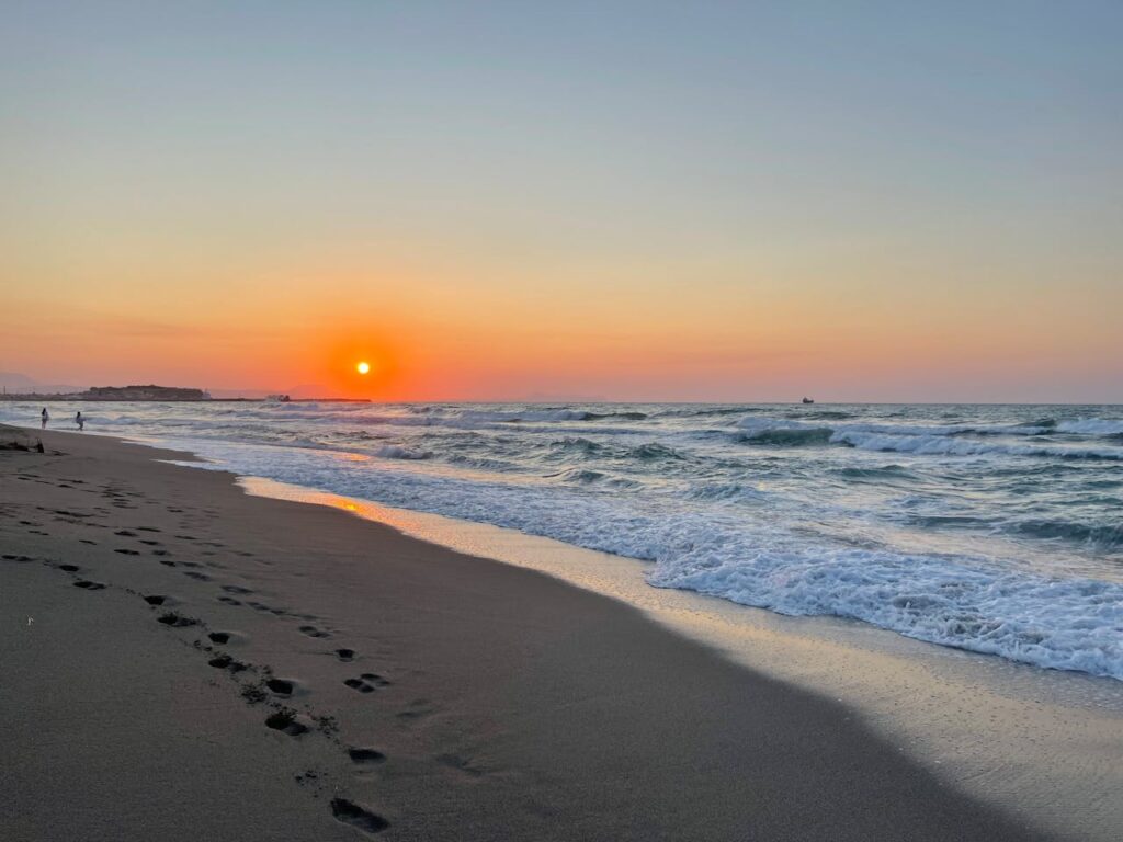 Beach at sunset with waves breaking