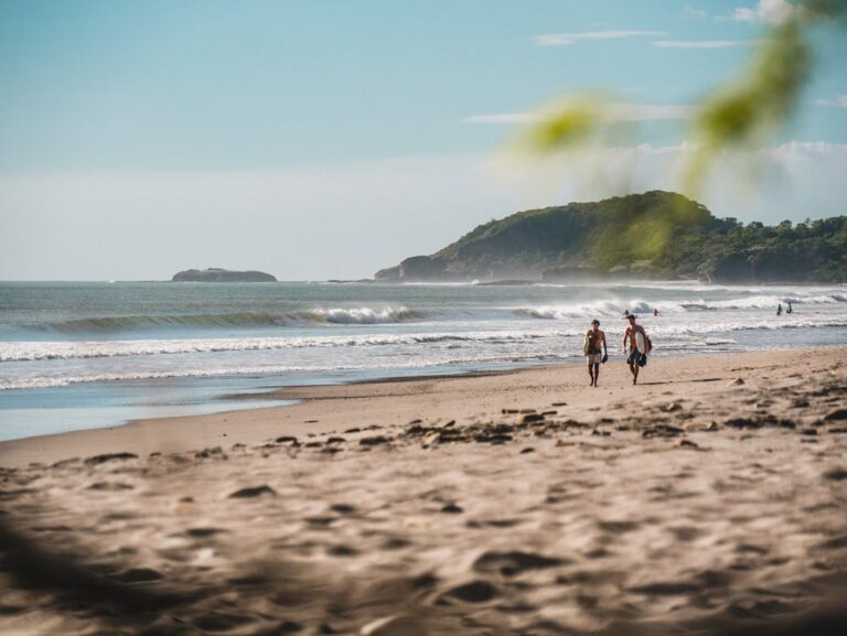 Two surfboarders walking on the beach in Nicaragua