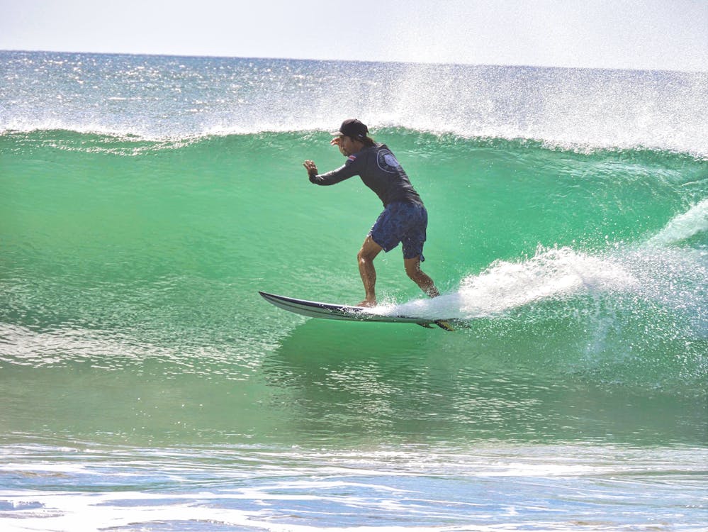 Surfer riding a wave in manuel Antonio