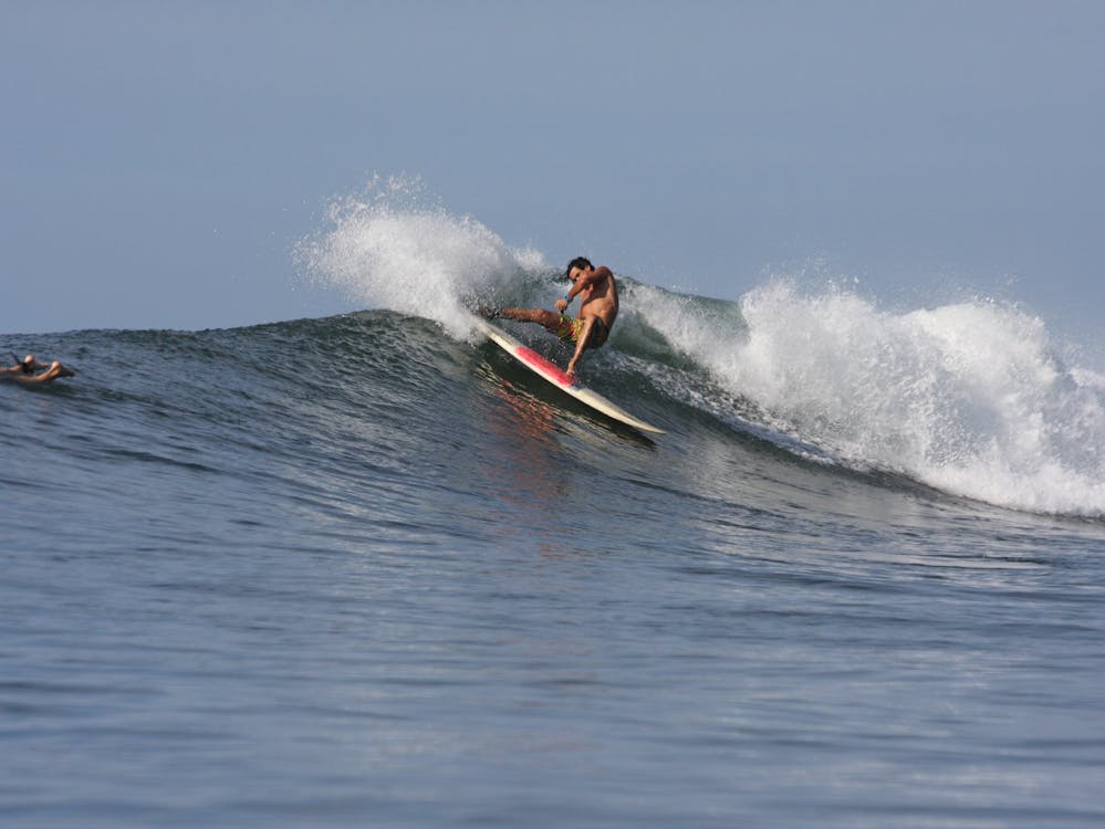 Surfing doing a turn on a right point breaker