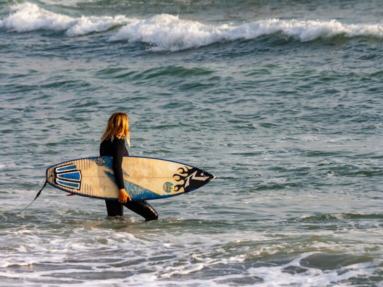 Surfer walking out in the water