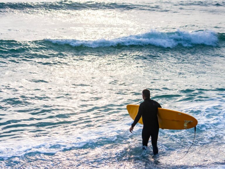 Photo of a surfer walking into the water