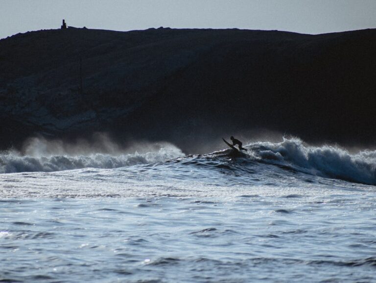 Photo of a surfer going over a wave in Peru