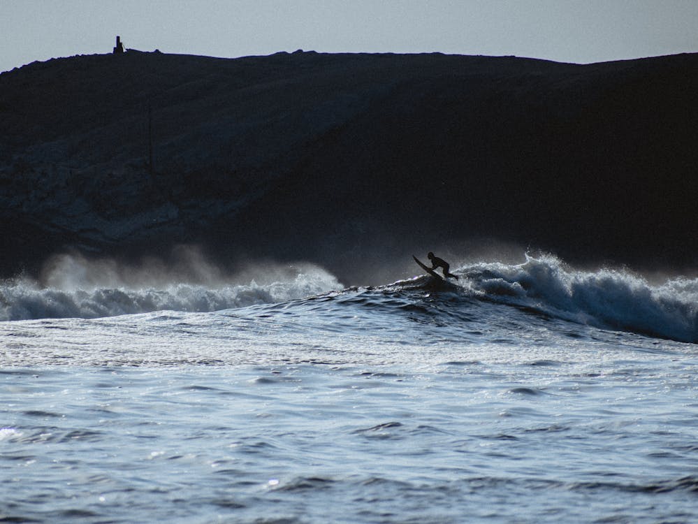 Surfing in Punta Hermosa. Photo of a surfer jumping over a wave