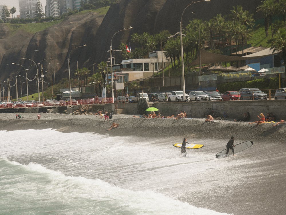 Surfers walking out of the water from Surfing in Lima