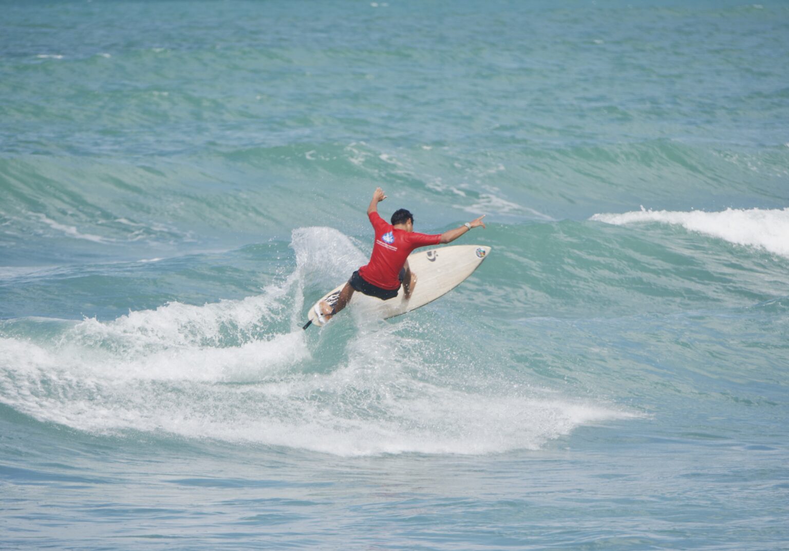 Someone enjoying the waves on Bang Tao. Photo provided by Bang Tao Surf School.