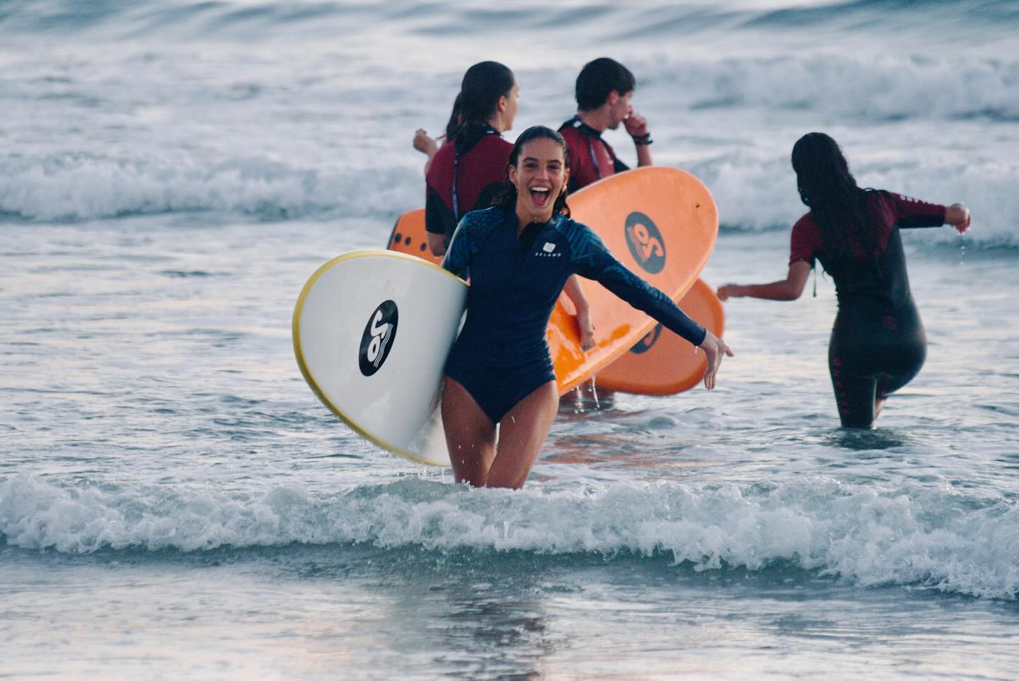 Smiles all around during a surf lesson with Antik Surf Club.
