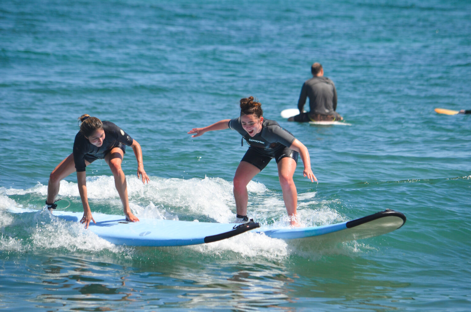 High Tide Los Cabos introducing two people to the love of surfing.