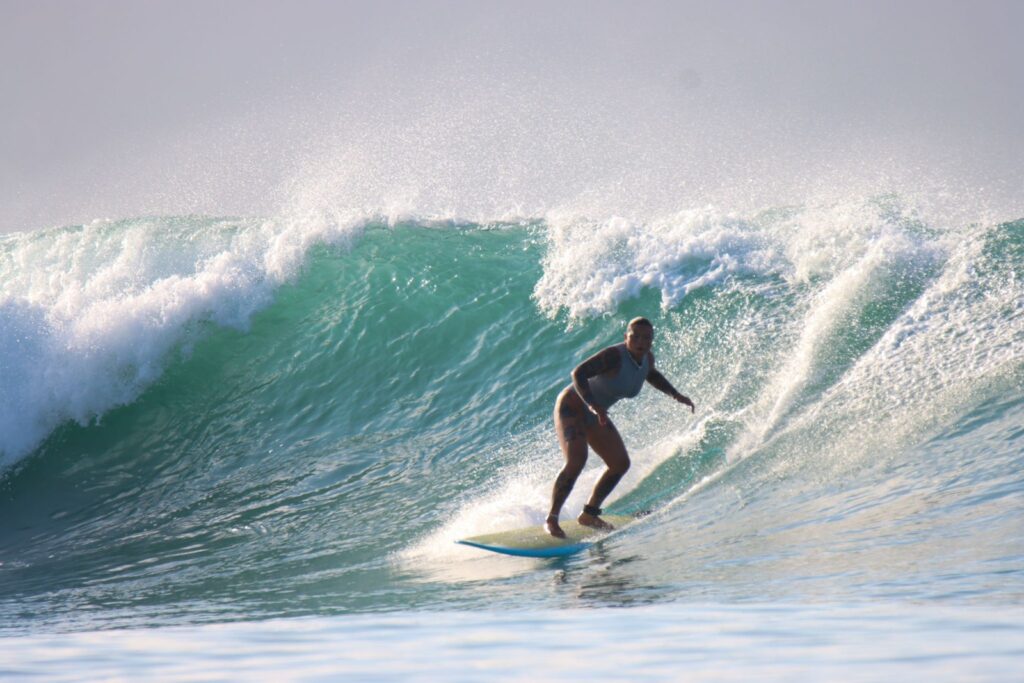 One of the students at DHM Surf Camp Lombok on a nugget!