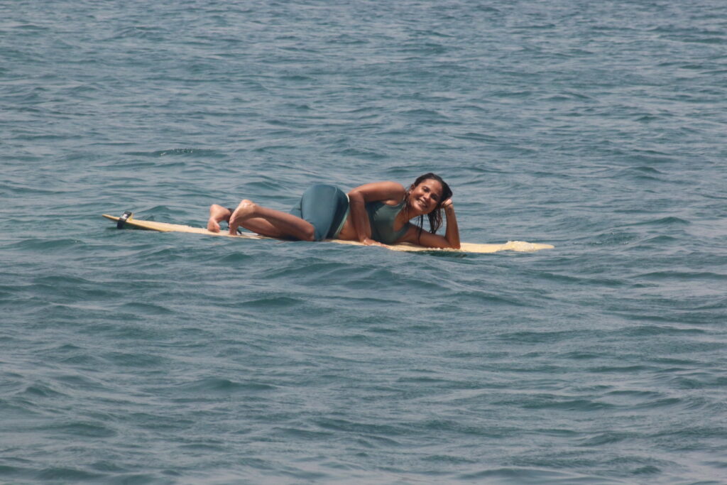 A DHM Surf Camp enjoyer refreshing themselves in the water while catching some waves.