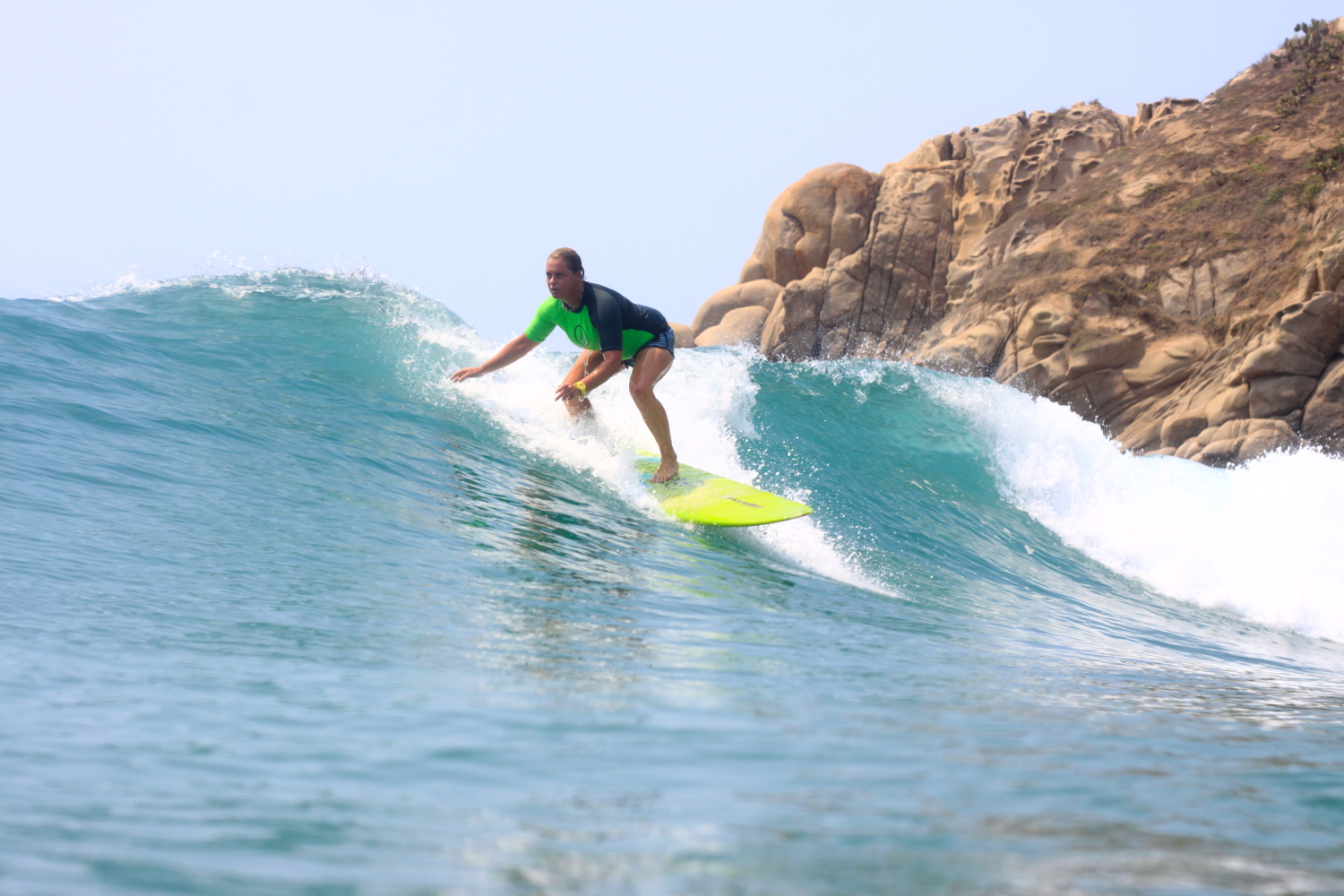 A student of Oasis Spanish & Surf School learning how to ride a wave, and enjoy the ocean.