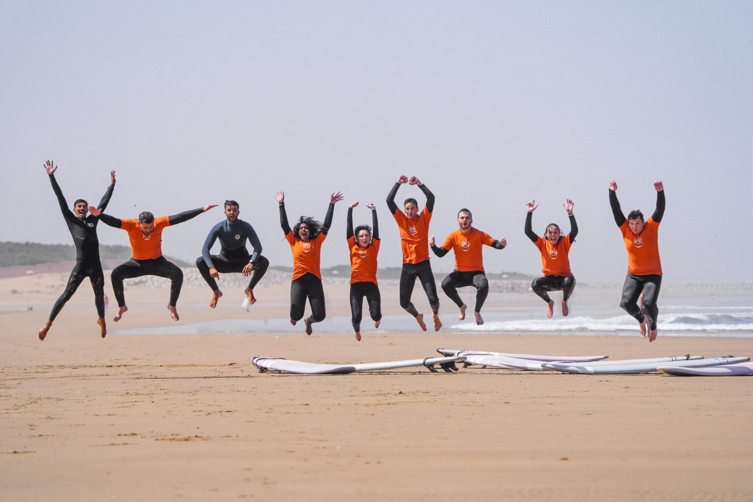 Some of the WaveRise instructors and their learners jumping with joy after a session.