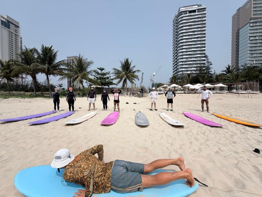 A group of beginners learning the basics in surfing from Surf Feeling.