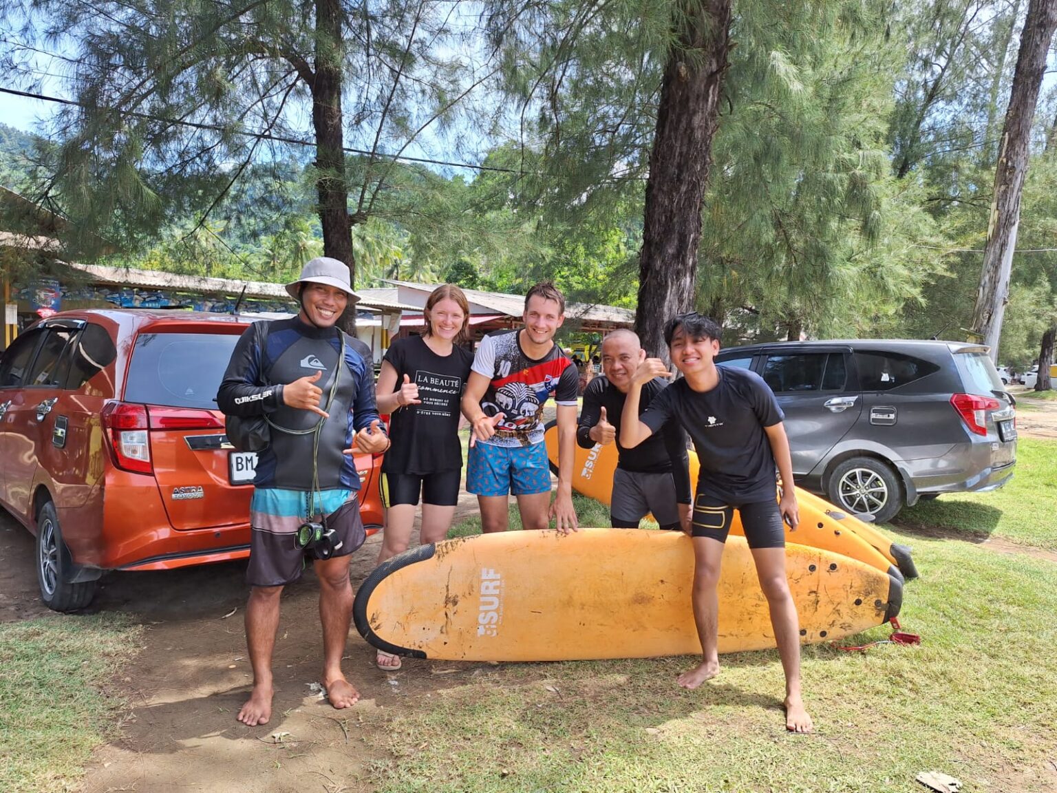 The owners of Air Manis Secret Surf Camp and a group of new surf enthusiatics throwing up the shaka.