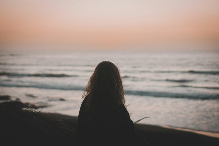 A girl enjoying the view of what Pichilemu has to offer to surf.