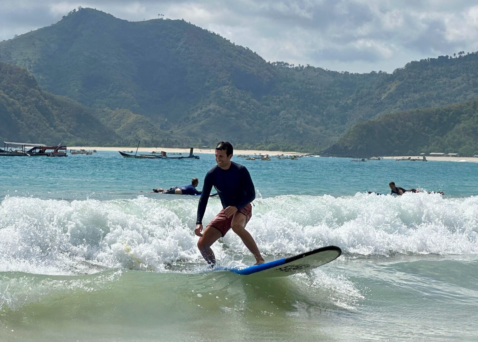 A surfer from Kairos Lombok, enjoying a lesson and learning the ropes of surfing.