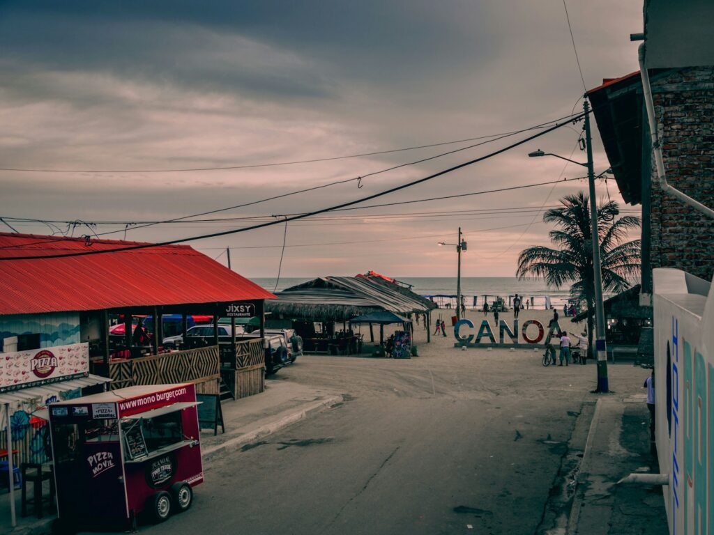Main street with the welcome sign to Canoa, Ecuador