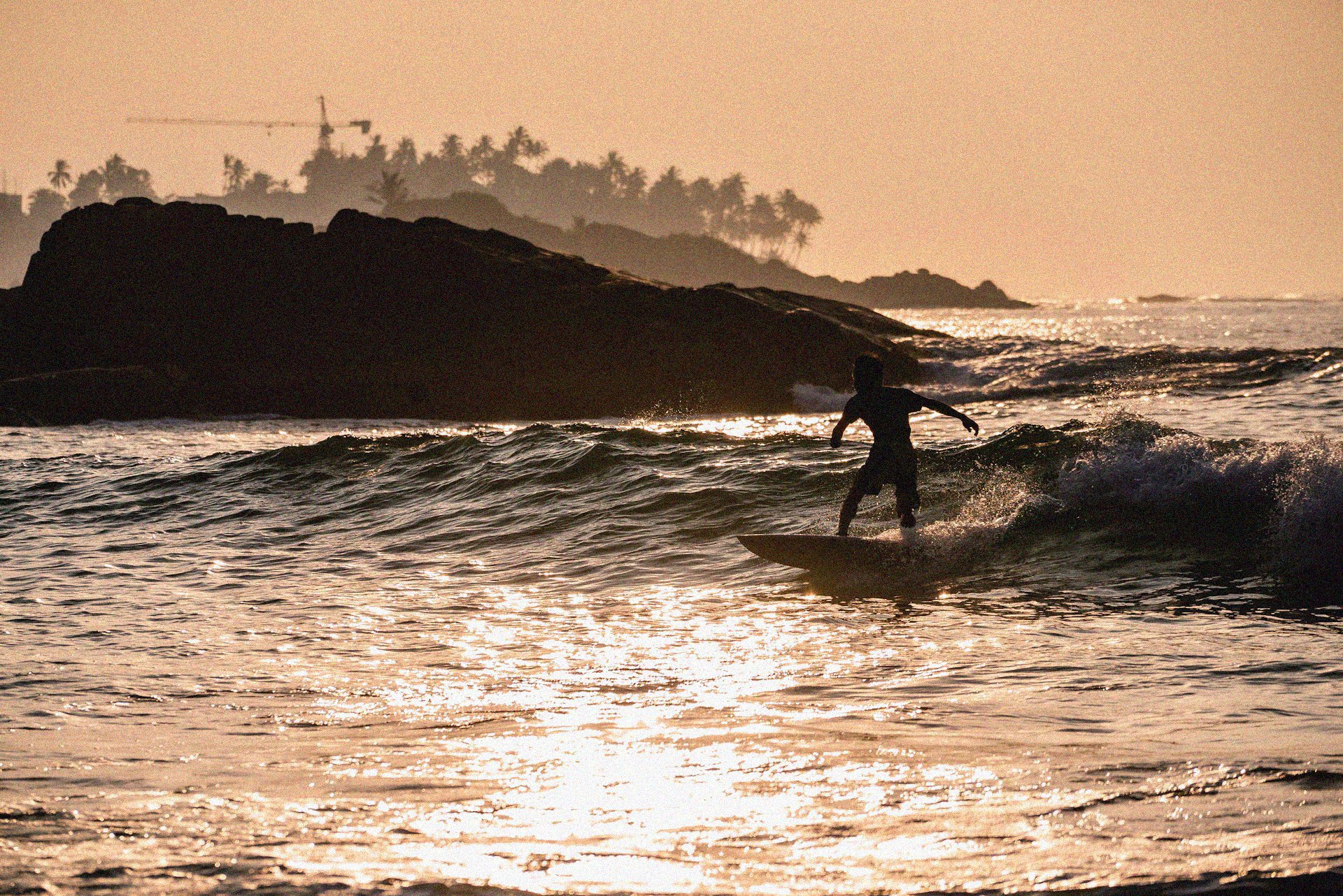 Someone enjoying a sunset session along the Mirrisa coastline.