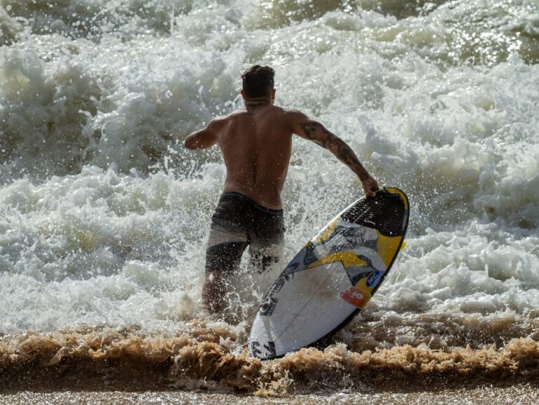 Surfer getting into the water