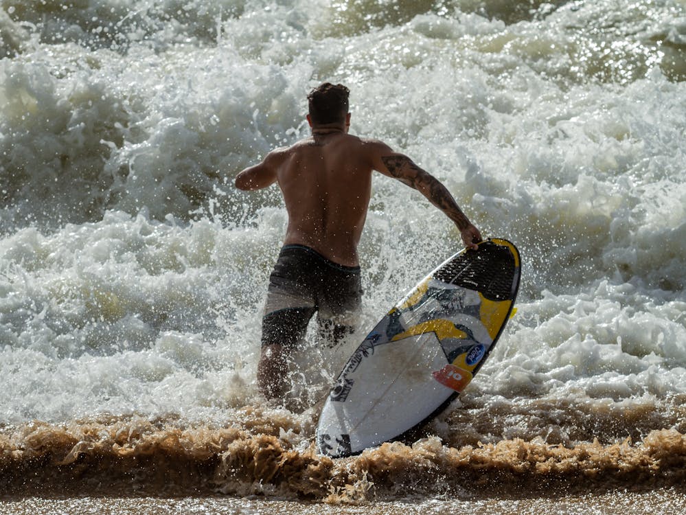 Surfer getting into the water