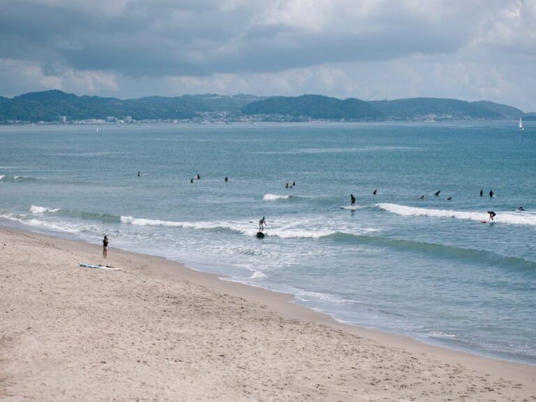Riders riding waves in Kamakura, Japan