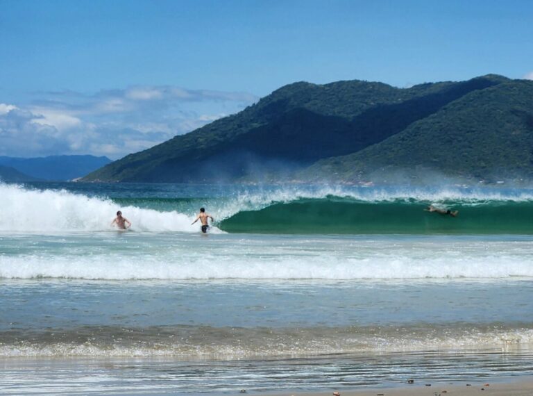 People in the water at Praia Guaeca
