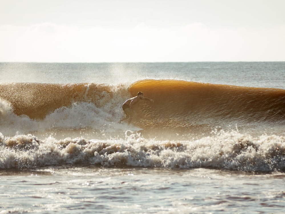 Surfer riding a wave in Nuqui, Colombia