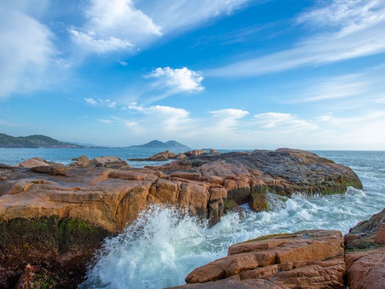 A coastal rock display with waves breaking over it