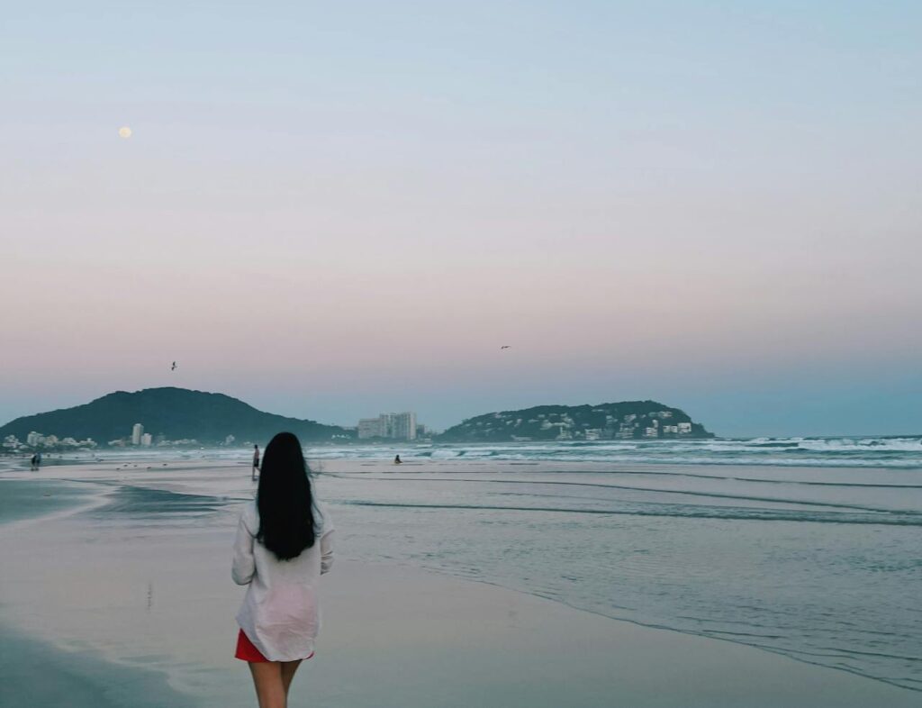 Girl walking on the beach of Itanhaem