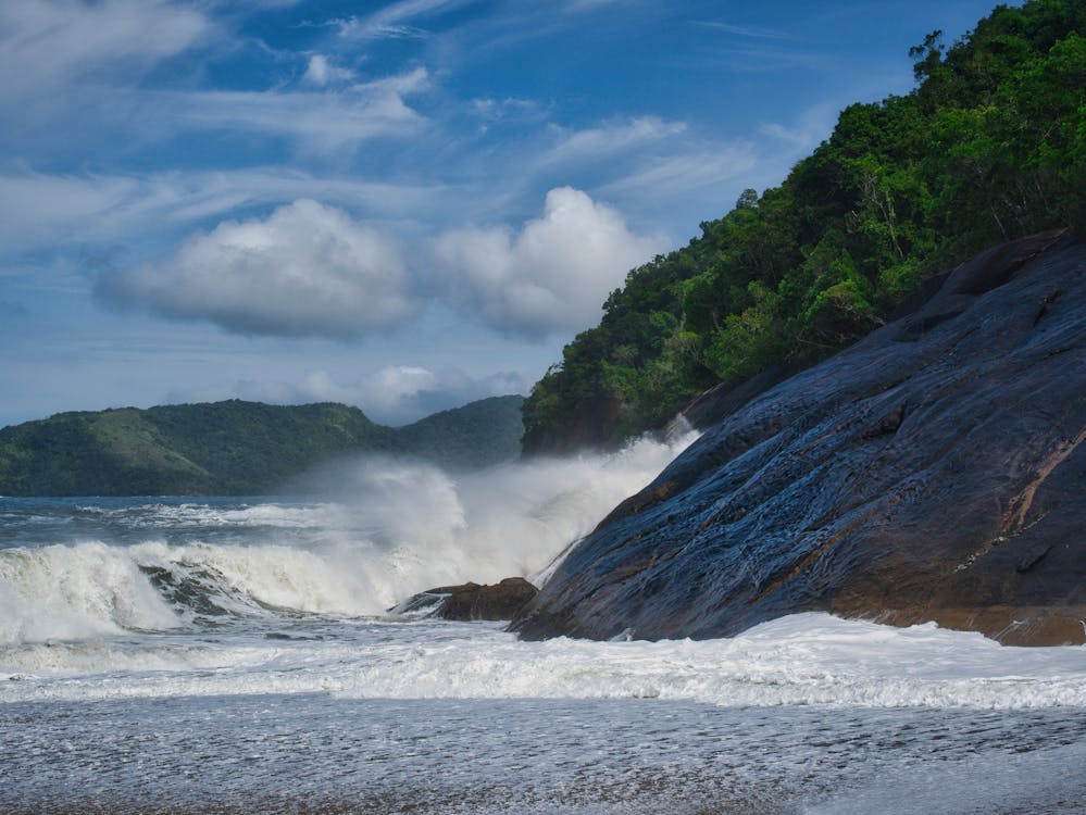 Waves breaking against a cliff in Ubatuba Brazil