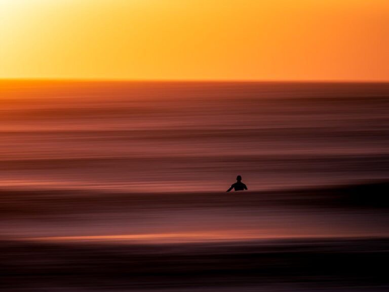 Beautiful photo of a surfer waiting for a wave at sunset