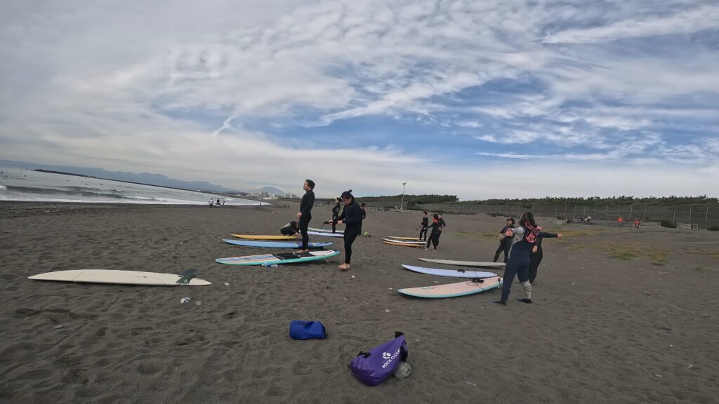 Some beginners learning the first steps to surfing with Hosoii Surf & Sports.