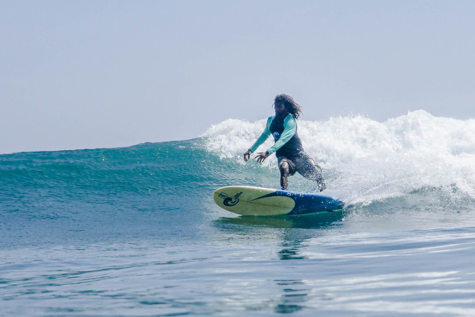 An individual from The Surf Weligama enjoying a wave in the bay.