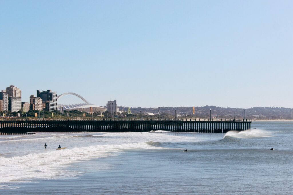 A shot of Durban from the water with multiple peaks breaking and people enjoying the waves.