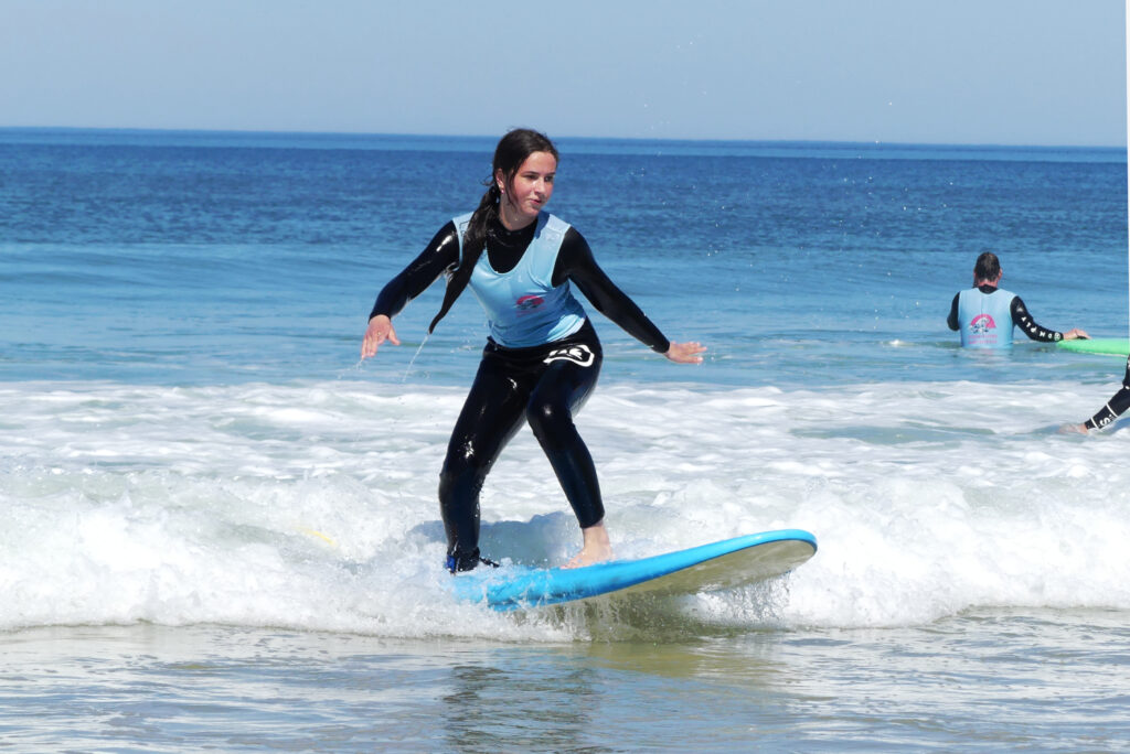 A shredder enjoying the day in the water by Ocean Lovers Surf School.